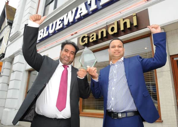 The Ghandi Restaurant in Kingston Road, Portsmouth won Curry House of the Year 2016. 

Pictured is owner Ruman Karim and manager Shakir Hussain 

Picture: Sarah Standing (160927-5520)