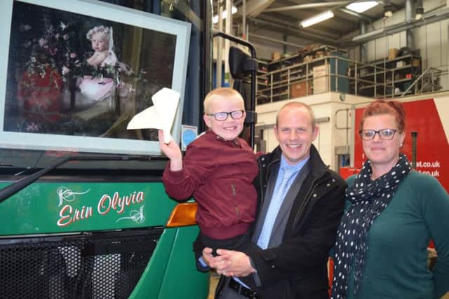 Alex Dunn and his father Chris and mum Helen with the number 74 truck that has Erin's name engraved on it