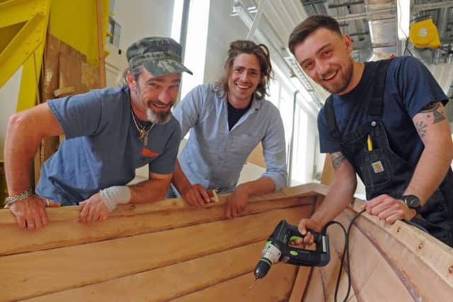 Students celebrate their graduation at the International Boat Building Training College at Portsmouth Historic Dockyard. From left, Pete Kelly, Julian Osborne, and Joseph Daley Picture: Ian Hargreaves (160856-1)