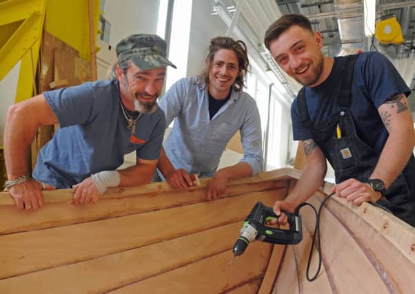 Students celebrate their graduation at the International Boat Building Training College at Portsmouth Historic Dockyard. From left, Pete Kelly, Julian Osborne, and Joseph Daley Picture: Ian Hargreaves (160856-1)
