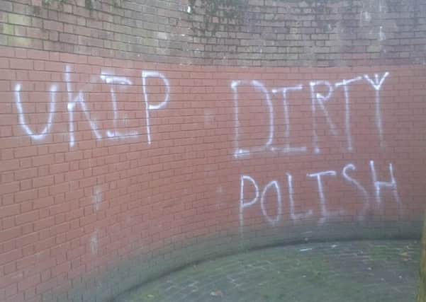 Graffiti showing 'UKIP' and 'DIRTY POLISH' spray-painted on the wall near the war memorial at Guildhall Square in Portsmouth evOjQFoHyCvZCib_68OE