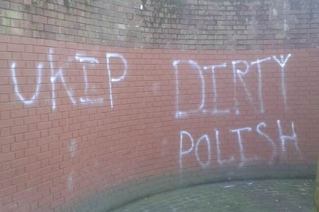 Graffiti showing 'UKIP' and 'DIRTY POLISH' spray-painted on the wall near the war memorial at Guildhall Square in Portsmouth evOjQFoHyCvZCib_68OE