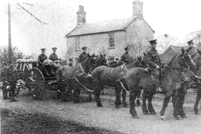 Drawn by six black horses, a coffin on a gun carriage draped with the Union Flag is drawn to its final resting place.