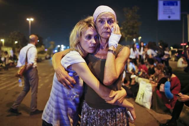 Passengers embrace each other as they wait outside Istanbul's Ataturk airport, early Wednesday, June 29, 2016 following their evacuation after a blast. (AP Photo/Emrah Gurel) TURKEY_Explosions_012551.JPG