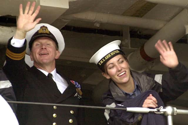 An HMS Ark Royal officer and a sailor wave to family on the quayside  PICTURE:JONATHAN BRADY