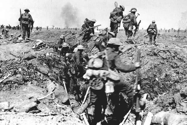 British troops negotiate a trench as they go forward in support of an attack on the village of Morval during the Battle of the Somme
