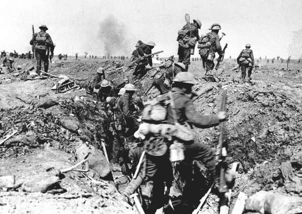 British troops negotiate a trench as they go forward in support of an attack on the village of Morval during the Battle of the Somme