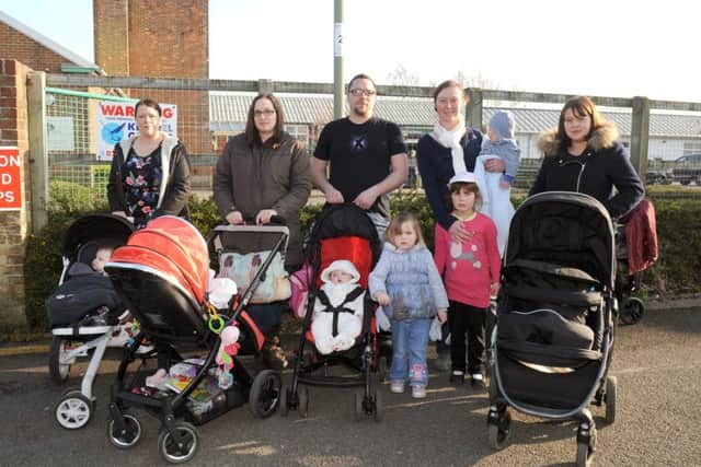(L-r) Campaigners and parents Gemma Blanks (32), Kirsty Wilson (32), Adam Darby (31), Rosalyn Fawcett (33), and Leanda Woodward (32) with their children outside The Haven Sure Start centre in Gosport