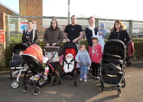 (L-r) Campaigners and parents Gemma Blanks (32), Kirsty Wilson (32), Adam Darby (31), Rosalyn Fawcett (33), and Leanda Woodward (32) with their children outside The Haven Sure Start centre in Gosport