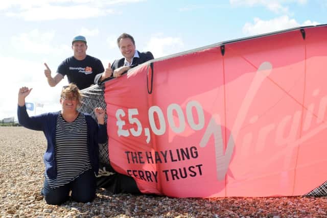 From left, Clare Satchwell, Hayling Ferry Trust, Dan Charlish, Virgin Kitesurfing Amarda and Mark Coates, Hayling Ferry Trust, celebrate Richard Branson putting money into saving the ferry (160886-2359)