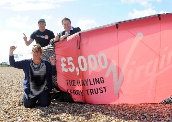 From left, Clare Satchwell, Hayling Ferry Trust, Dan Charlish, Virgin Kitesurfing Amarda and Mark Coates, Hayling Ferry Trust, celebrate Richard Branson putting money into saving the ferry (160886-2359)