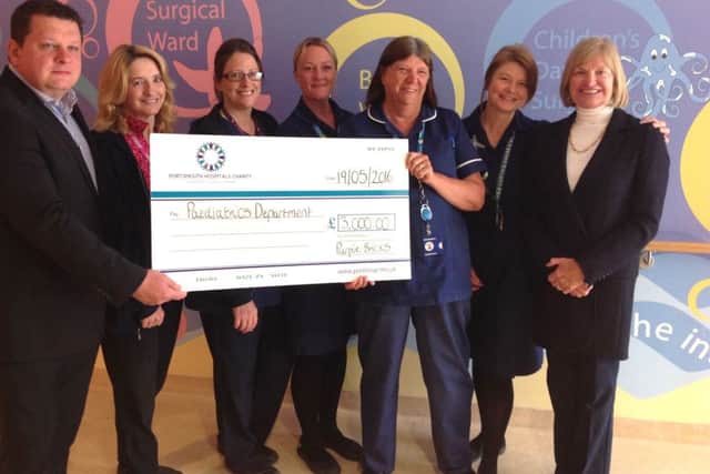 Staff from Purplebricks with a cheque for the Children's Assessment Unit at Queen Alexandra Hospital