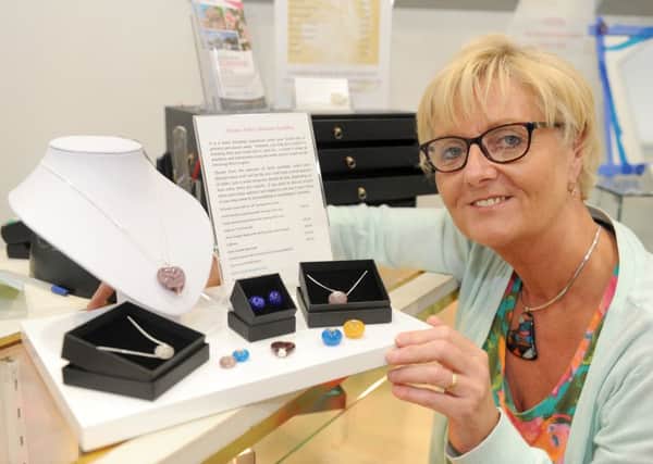 Karen Taylor makes jewellery from cremation ashes

Picture: Sarah Standing (160814-2505)