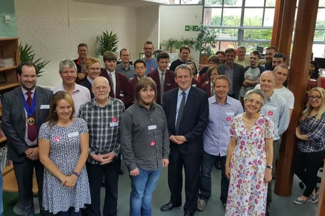 Damian Hinds, the MP for East Hampshire (sixth right, front row), deputy mayor of Petersfield Jamie Matthews (far left) and students from The Petersfield School and Insync employees