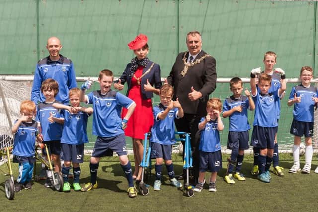 Mike Pink, disability co-ordinator at Pompey in the Community, Mayoress Mrs Leza Tremorin and Mayor Cllr David Fuller and some of the footballers give the thumbs up to their new kit