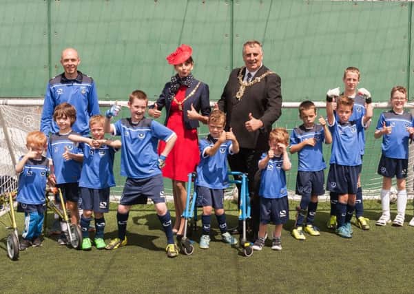 Mike Pink, disability co-ordinator at Pompey in the Community, Mayoress Mrs Leza Tremorin and Mayor Cllr David Fuller and some of the footballers give the thumbs up to their new kit