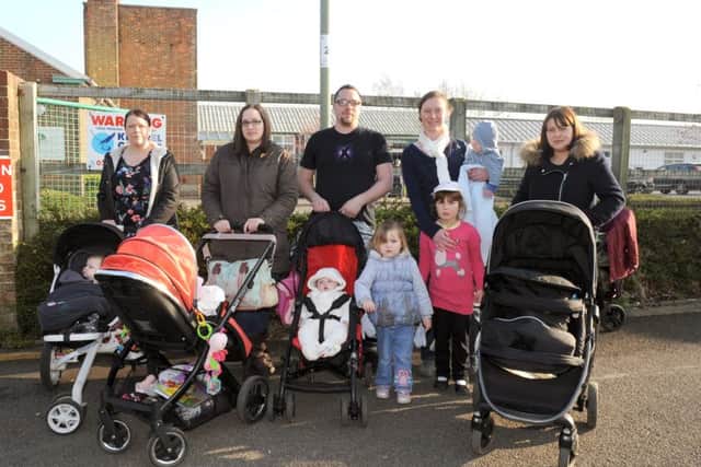 (L-r) Parents Gemma Blanks (32), Kirsty Wilson (32), Adam Darby (31), Rosalyn Fawcett (33), and Leanda Woodward (32) with their children outside The Haven Sure Start centre in Gosport