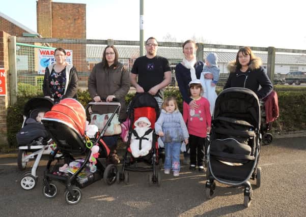 (L-r) Parents Gemma Blanks (32), Kirsty Wilson (32), Adam Darby (31), Rosalyn Fawcett (33), and Leanda Woodward (32) with their children outside The Haven Sure Start centre in Gosport