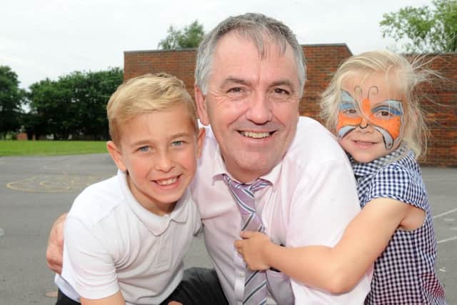 8/7/2016 (JT)Headteacher Colin Harris from Warren Park School in Havant, is retiring after 21 years. Pictured is: Headteacher Colin Harris with Stanley Crockford (8) and Jessie Green (5). Picture: Sarah Standing (160942-6463)