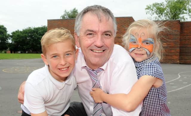 8/7/2016 (JT)

Headteacher Colin Harris from Warren Park School in Havant, is retiring after 21 years. 

Pictured is: Headteacher Colin Harris with Stanley Crockford (8) and Jessie Green (5). 

Picture: Sarah Standing (160942-6463)