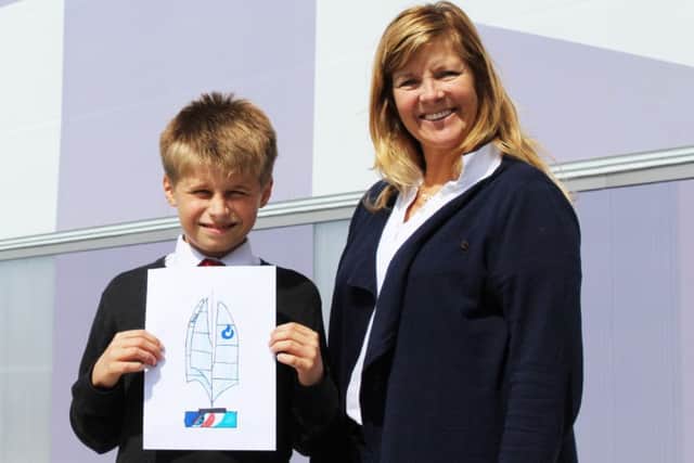 Zak Kay holding his winning design, with America's Cup World Series event director Leslie Greenhalgh