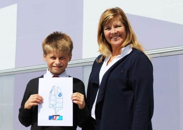 Zak Kay holding his winning design, with America's Cup World Series event director Leslie Greenhalgh