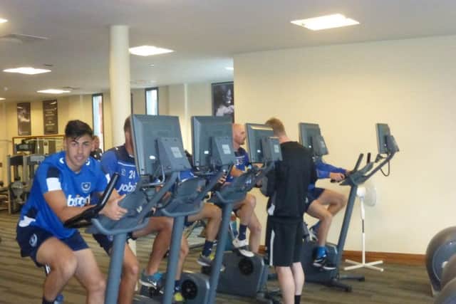 Triallist goalkeeper Eric Grimes joins his Pompey tour team-mates on the spinning bikes     Picture: Neil Allen