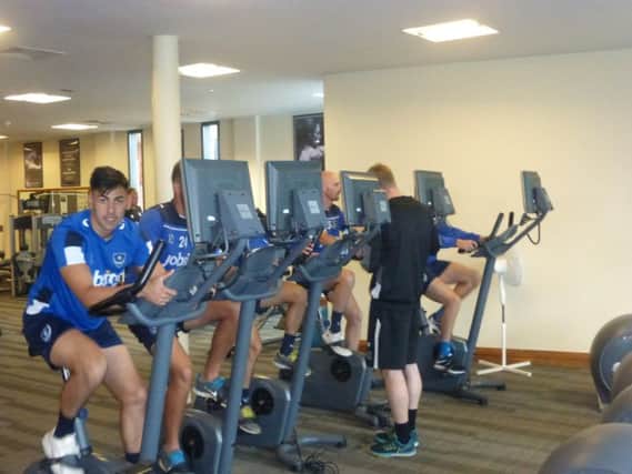 Triallist goalkeeper Eric Grimes joins his Pompey tour team-mates on the spinning bikes     Picture: Neil Allen