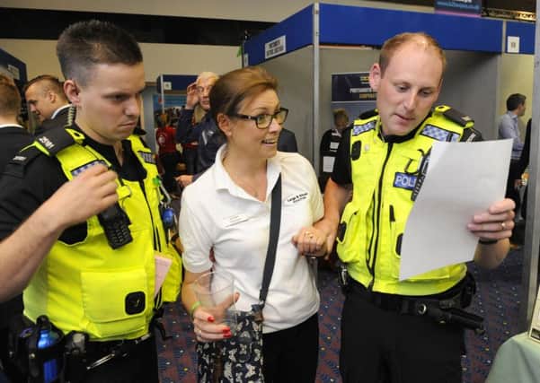 Rachel Harvey, the office manager for Large & Gibson Solicitors was 'arrested' by police officers PC Dane Millerchip, left, and PC Dan McGarrigle at The Pyramids Portsmouth Business Expo to raise funds for The Elizabeth Foundation 

Picture:  Malcolm Wells (160707-4966)