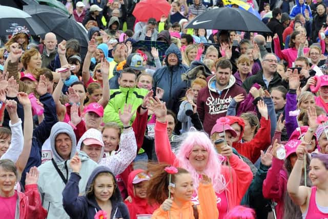 Hundreds of runners and walkers alike were not deterred by the inclement weather on Sunday morning for the 2016 Race for Life held on Southsea Common  Picture by Malcolm Wells (160710-5602)