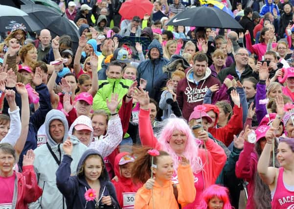 Hundreds of runners and walkers alike were not deterred by the inclement weather on Sunday morning for the 2016 Race for Life held on Southsea Common  Picture by Malcolm Wells (160710-5602)