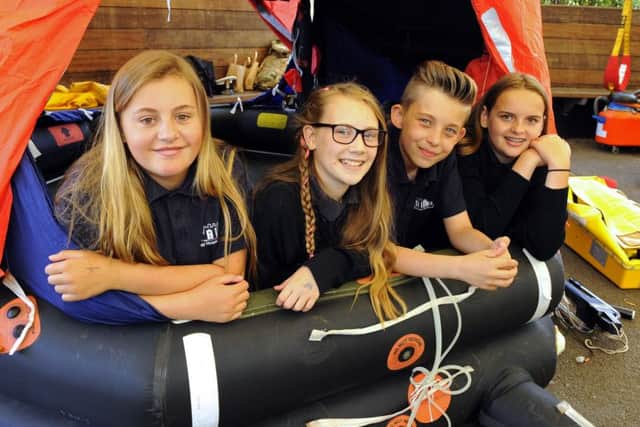 (L-r) Year 7 pupils Maddy Ward (12), Lucy Stokes (12), Charlie Harris (11) and Mia Brans (11) try a survival craft