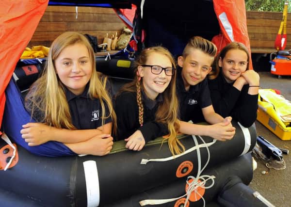 (L-r)  Year 7 pupils Maddy Ward (12), Lucy Stokes (12), Charlie Harris (11) and Mia Brans (11) try a survival craft