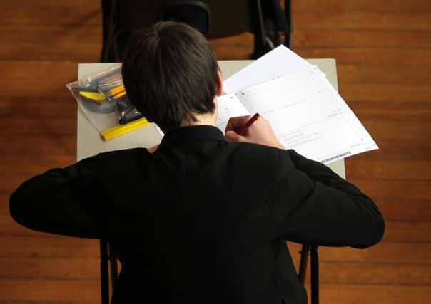 File photo dated 02/03/12 of a pupil sitting a maths exam as too many students are starting science and engineering degrees without studying maths at A-level, according to a report. ENGPPP00120120814145127