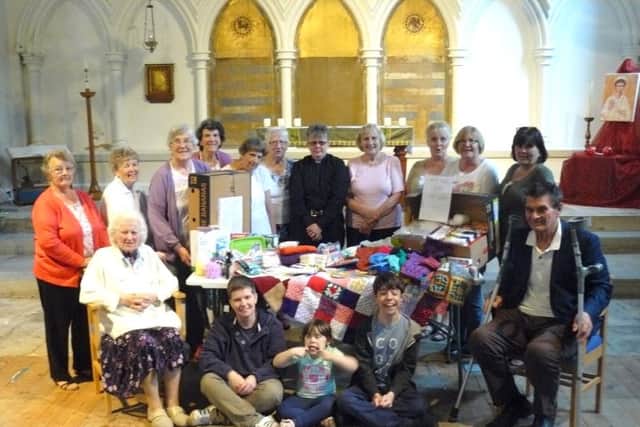 Parishioners with items they have made for the victims of the civil wars in Iraq and Syria