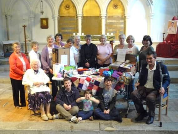 Parishioners with items they have made for the victims of the civil wars in Iraq and Syria