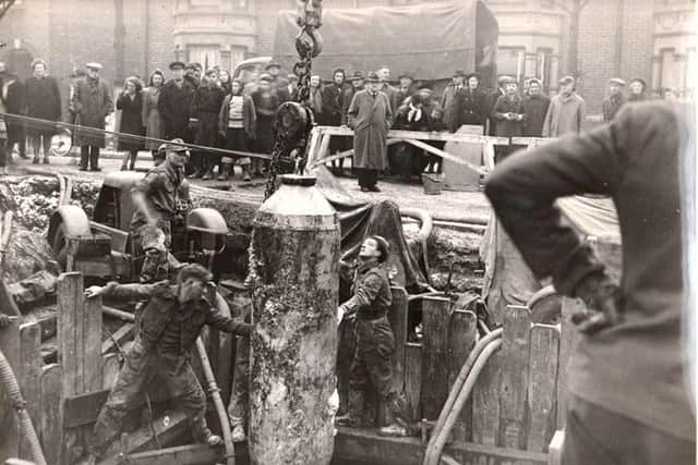 CAREFUL LADS The unexploded bomb being extracted from Torrington Road, North End, Portsmouth in 1946