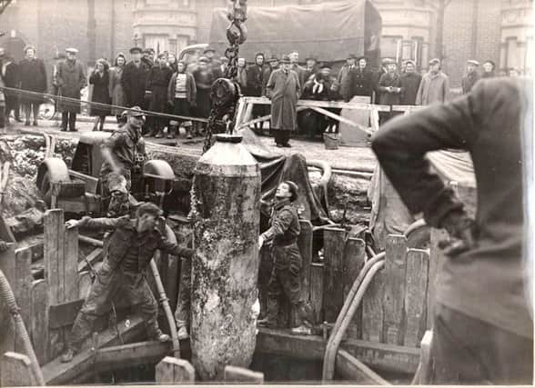CAREFUL LADS The unexploded bomb being extracted from Torrington Road, North End, Portsmouth in 1946
