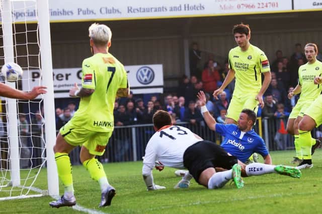 Noel Hunt slides in to score against the Hawks. Picture: Joe Pepler