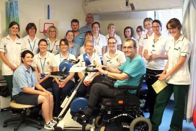 Queen Alexandra Hospitals Neuro Physiotherapy Team with Ray Nevitt, on the bike