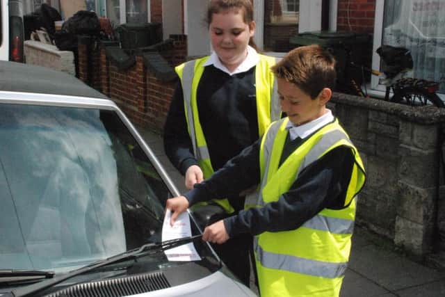 Isambard Brunel Junior School pupils hand out 'parking fines' to help improve road safety around their school