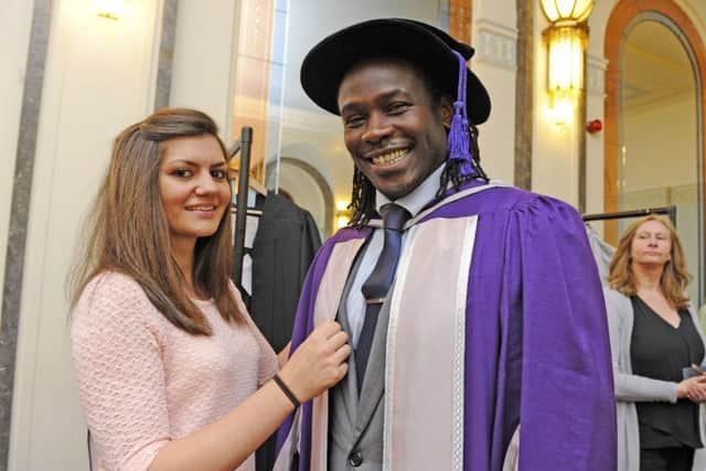 Gown Dresser Emma Eggleton (24) ensures that Linvoy Primus is immaculate in his gown
Picture by: Malcolm Wells (160715-6760)