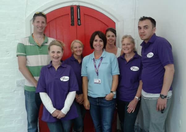 Employees from Pfizer in Havant helped out  with a makeover of the old parcel office at Petersfield train station