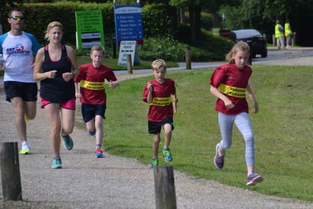 Left to right: Daniel Farmer, Sarah Moulding, Jake Farmer, Oliver Moulding and Jessica Moulding enjoy their Saturday morning parkrun at Fareham on Saturday. Picture: Peter Stoddard