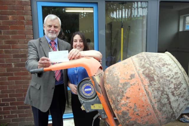 President of Gosport Rotary Club Ken Eckersley hands over the cheque to Motiv8 Gosport and Fareham services manager Kirsty Cremer