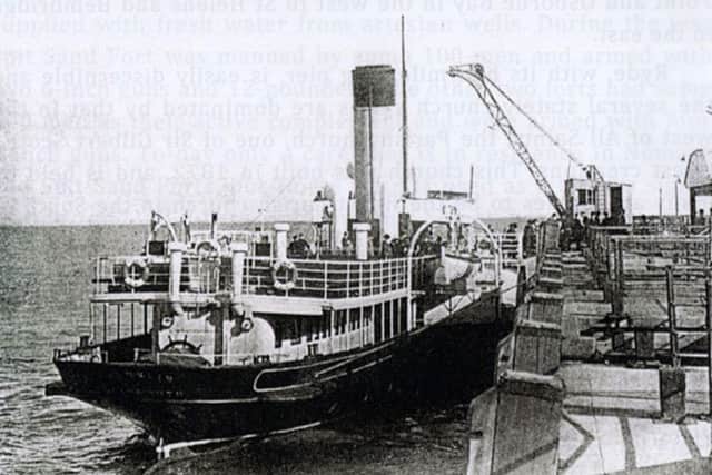 Passengers from a paddle steamer disembark at Ryde Pierhead. Was the wheel above the rudder used when going astern?
