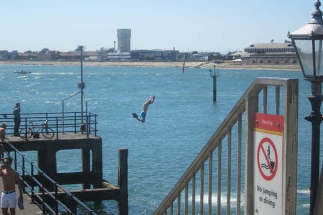 A picture taken by Graham Dooley of a man leaping into the sea from Sally Port in Old Portsmouth