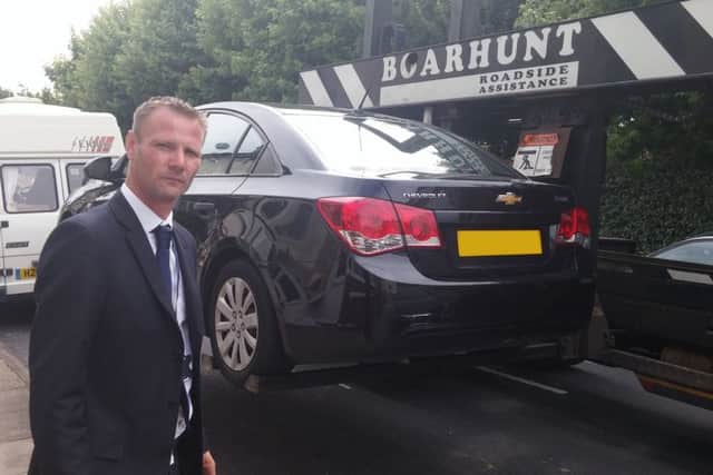 Cllr Jim Fleming watches as a car is removed in a crackdown in Portsmouth. Picture: Portsmouth City Council