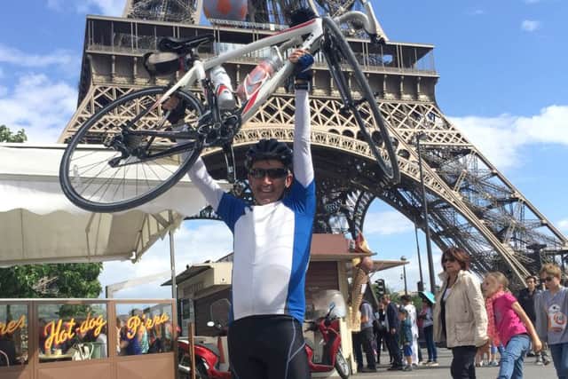 Gary Mullins, 55, completing his journey underneath the Eiffel Tower