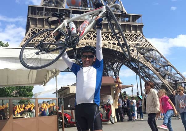 Gary Mullins, 55, completing his journey underneath the Eiffel Tower
